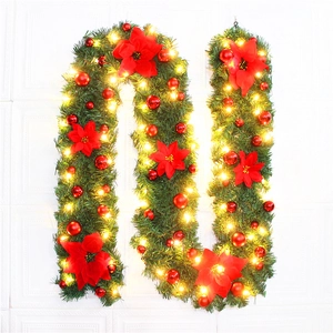 Detail of 2.7m lighted Christmas garland with red poinsettia flowers and gold balls