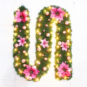 Close-up of 2.7m lighted Christmas garland with pink flowers and warm LED bulbs