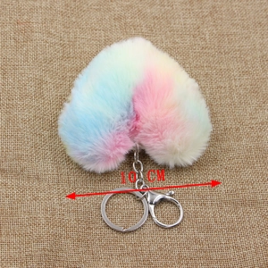 Rainbow plush heart keychain measuring 10 cm with a metal ring on a burlap background