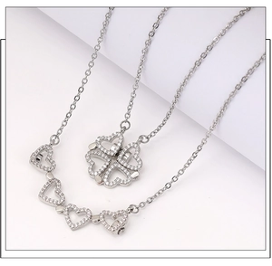 Detailed view of silver magnetic necklace transforming from clover to four hearts