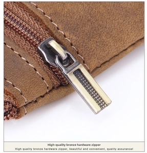 Macro shot of crazy horse leather stitching and bronze hardware zipper detail