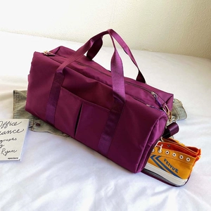 Detail of purple fitness bag showing side shoe compartment and water-resistant fabric