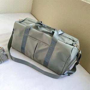 Detail view of large pale green travel bag with water-resistant nylon and wide straps