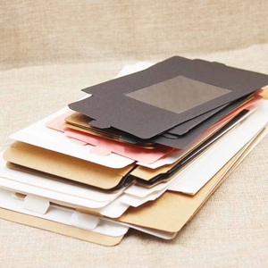 Detail view of colorful kraft paper boxes with PVC window in black, white, and pink