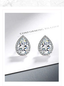 Macro shot of silver teardrop stud earrings featuring pear-cut clear cubic zirconia stones