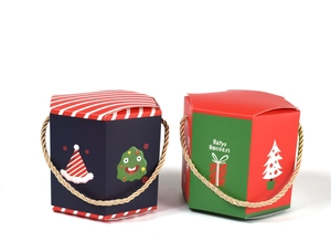 Detail of hexagonal Christmas gift boxes in red and blue with gold braided handles