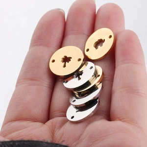 Polished stainless steel round charms with palm tree cutouts in gold and silver finish