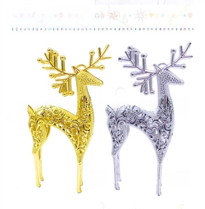 Detail view of hollow-out reindeer ornaments in gold and silver with hanging loops