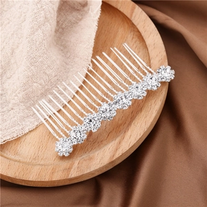 Detailed view of bridal hair comb with silver sunflower rhinestones and pearls on silk
