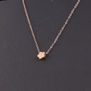 Close-up of rose gold flower pendant with polished finish and delicate link chain