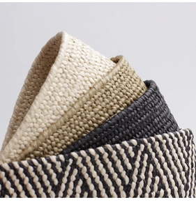 Close-up of woven straw belts showing detailed texture and diverse color patterns