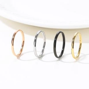 Minimalist stackable titanium steel rings in gold, silver, black, and rose gold finishes