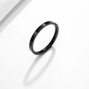 Minimalist black stainless steel band ring with sleek polished finish and shadow detail