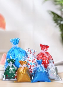 Detail of assorted Christmas drawstring gift bags with festive patterns and ribbon closure