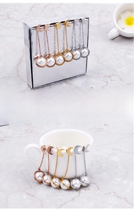 Vue détaillée des boucles d'oreilles lune avec longs pompons de perles en or et argent