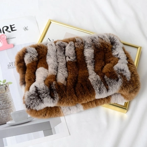 Close-up of soft brown and white rabbit fur texture on a folded winter neck warmer