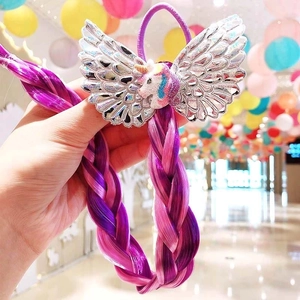 Close-up of unicorn sequins and purple braided hair extensions for girls hair decoration