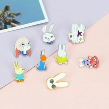 Detailed view of eight assorted cartoon bunny enamel lapel pins on a colorful background