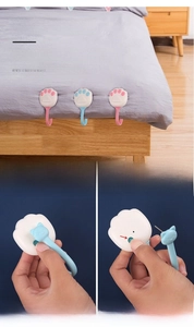 Close-up of pink cat paw duvet clips showing mechanical lock and needle mechanism