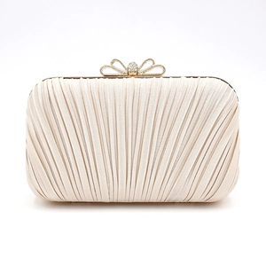 Elegant pleated cream evening clutch bag with a golden bow-knot rhinestone clasp
