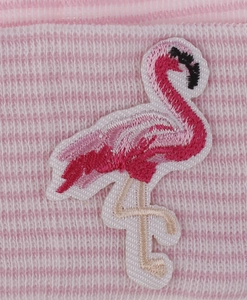 Macro detail of flamingo embroidery on pink and white striped knitted baby beanie fabric