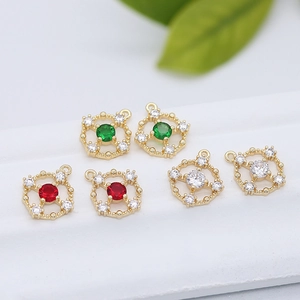 Macro shot of 14k gold-plated jewelry charms with green, red and white crystals