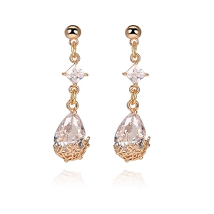 Detail of 18K gold drop earrings with floral filigree base and clear zircon crystals