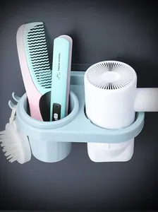 Detail of light blue wall-mounted hair dryer holder with multi-compartment storage hooks