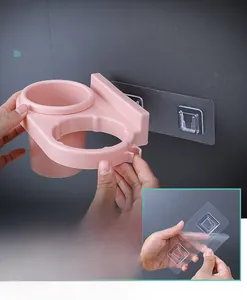 Detail view of pink wall-mounted hair dryer holder with strong adhesive backing