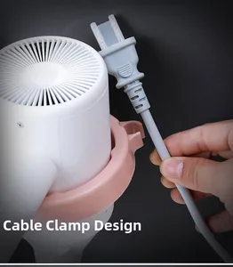 Detail showing the cord clip design on a pink wall-mounted hair dryer holder