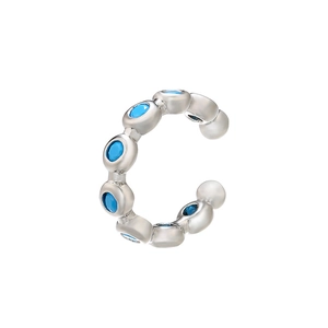 Detailed close-up of silver ear cuff with inlaid sparkling blue zircon gemstones