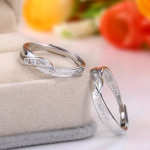 Macro shot of silver S925 couple rings with Promise engraving in a velvet jewelry box