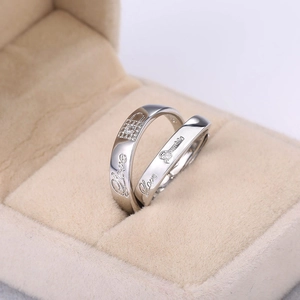Classic silver couple rings with lock and key design and Love engraving in a jewelry box