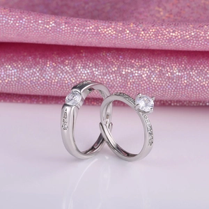 Detailed close-up of adjustable silver couple rings with heart zirconia and paved stones