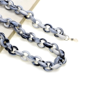 Macro detail of black and white marble acrylic eyeglass chain with secure metal lobster clasp