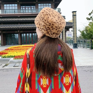 Detailed back view of a plush leopard print faux fur hat paired with a colorful shawl