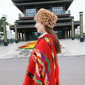 Detail of winter leopard faux fur hat and red geometric pattern knit poncho set