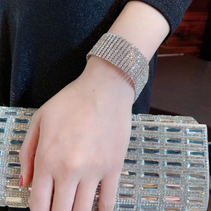 Elegant silver wide multi-row rhinestone bracelet and matching luxury crystal evening clutch bag