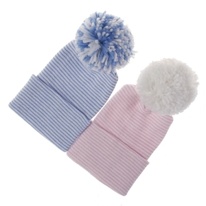 Detailed view of striped newborn knitted beanies in pink and blue with soft pom-poms