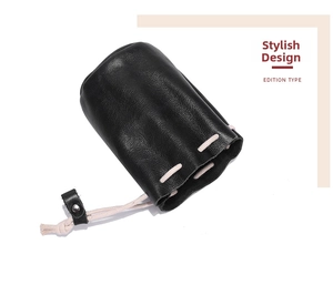 Close-up of black leather drawstring pouch with lychee texture and cream cotton cord