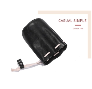 Detail of black oil wax cowhide drawstring pouch for coins and lipstick storage