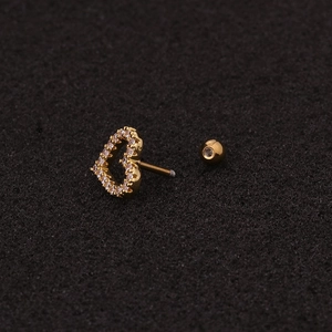 Golden heart screw back stud earring with clear zircon inlay on dark texture background