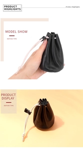 Detail of black pebbled leather drawstring pouch showing texture and cream cord