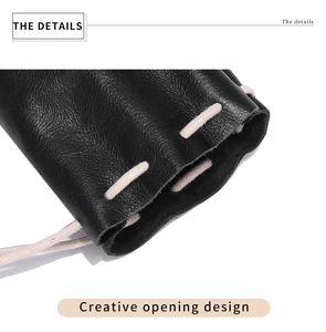 Detail view of the black leather coin pouch showing the creative drawstring opening