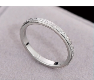Macro shot of silver titanium steel ring with matte exterior and polished inner surface