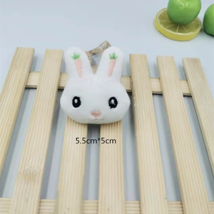 Detail of 5.5x5cm plush rabbit brooch with pink carrot embroidery on ears