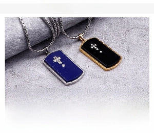 Detail of stainless steel military dog tag pendant necklaces with cross in gold and steel