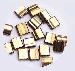 Macro shot of polished gold square two-hole glass beads for DIY jewelry making