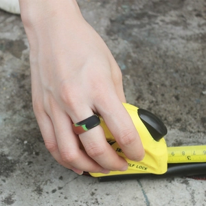 Detail of a 8.7mm wide camo silicone sports ring shown with a measuring tape scale
