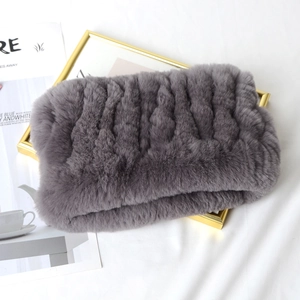 Macro shot of grey faux fur neck warmer texture on a decorative golden frame background